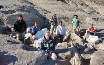 a tem of researchers standing by the excavation site